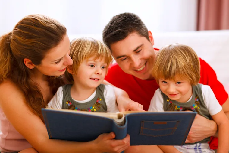 Family looking through printed photos before scanning and digitising in Perth